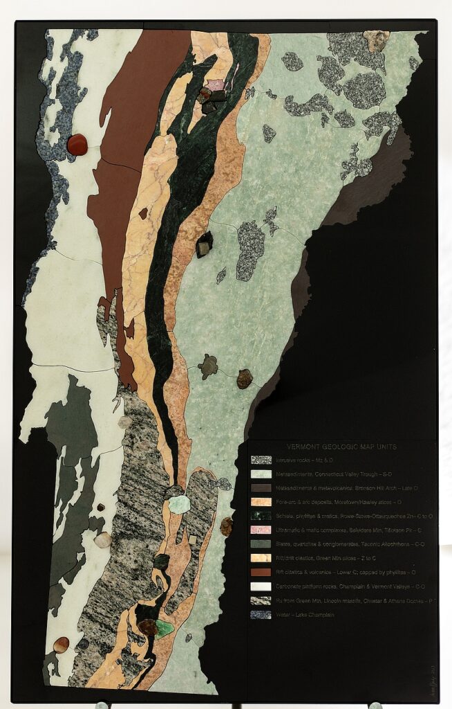 A stone geologic map of Vermont with different colored rocks