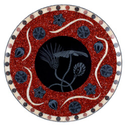 A red and black plate with some designs on it