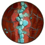 Red Rupture <br>
16" diameter, 2009 <br>
Red jasper, cuprite with chrysocolla, amazonite crystals, slate, tourquoise, tile A red and brown plate with turquoise stones on it.