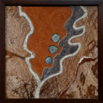 Cleavage II- Aqua Aura <br>
13" x 13", 2013 <br>
Marble, stromatolite, granite, quartz concretions coated with gold A picture of the earth with rocks and water.