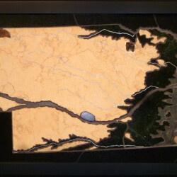 Nebraska Geologic Map in Stone
29.5626" x 12.375", 2014
Stone: Fossiliferous limestone, orbicular rhyolite, epidote conglomerate, fossiliferous jasper, sodalite syenite, agate, slate
Specimens: blue chalcedony drusy, gabbro, fossilized palm wood, fossilized artiodactyls tooth - Merycoidodon culbertsoni, fossilized brachiopod, fossilized shark teeth A geologic map of Nebraska created with different colored stones