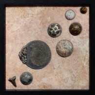 Earth Sampler II: Pyritized Ammonite & Barite <br>
13" x 13", 2014 <br>
Travertine, spheres of tiger eye, coral, breccia, septarian nodule, feldspar, picasso marble; shark tooth, ammonite, barite crystal with pyrite A group of different types of buttons on the ground.