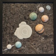 Earth Sampler Series XIV: Fairy Stone <br>
13" x 13", 2017 <br>
Marble; gold bonded chalcedony rose, calcite concretion, sea urchin; spheres of blue quartz, graphic granite, chrysocolla & malachite, sunstone, and orbicular jasper A group of planets sitting on top of a table.