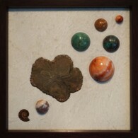 Earth Sampler Series XVIII: Pyrite Sun <br>
13" x 13", 2017
<br>
Marble; pyrite sun; spheres of red jasper, starburst rhyolite, chrysocolla & cuprite, chrysocolla, carnelian and agate; ammonite A picture of some planets and a leaf.