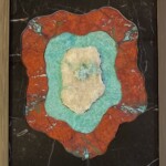 Blue Flame Revelation <br>
13.5” x 11.25”, 2023 <br>
Marble, cuprite, amazonite, stilbite with apophyllite crystals A painting of a red and blue stone