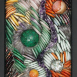 Pebbles V: Path of Perseverance<br>
7" x 10.4", 2018 <br>
Stone discs of rose quartz, amethyst, rhodochrosite, jade, agate, aragonite, obsidian, mookaite, and aventurine; spheres of rhodochrosite, mookaite, ocean jasper, malachite; amethyst specimen A colorful picture of various items in the shape of an abstract design.