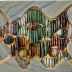 Pebbles VI - Pebbles in the Sand <br>
6.0" x 7.5" x 1.75", 2024 (January) <br>
Dumortierite quartzite; discs of amethyst, jade, aventurine, rhodonite, rose quartz, jasper, and unakite A close up of the bottom part of a sculpture