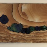 Pocket XVII: Treasured Seep <br> 7.75” x 22.75” x 1.5”, 2021 <br> Liesegang banded (Kanab) sandstone; malachite crystals, azurite crystals, azurite and malachite concretions A painting of trees and rocks on wood.