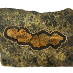 Striking Fire, Worlds Apart <br>
14.25” x 18.75”x 3.0”, 2023 <br>
Chalcopyrite, marble, gabbro; barite with pyrite crystals A piece of rock with a picture on it