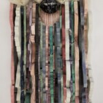 Waves XI: Physalia Revisited <br> 18 1/4" x 9" x 2 1/2", 2019 <br> Quartz crystal with dogstooth calcite; Rhodonite, slate, marble, sodalite, fuchsitic chert, dumortierite, piemontite, charoite, lepidolite, amazonite, chrysocolla in quartz, dumortieritic quartzite, agate, mookaite, opalized fluorite <br> Sphere: jasper; Stone discs: rose quartz, aventurine A wall hanging made of strips of wood.