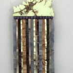 Waves XV: Nickeloan Forest <br> 9 1/2" x 4 1/2" x 2", 2019 <br> Nickeloan magnesite, amethystine microcrystalline chalcedony spherules; quartzite, alabaster, slate, magnesite, sandstone, piemontite, agate A piece of art made from wood and glass.