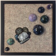 Earth Sampler Series XXIV: Violet Encore <br>13" x 13", 2018<br> Syenite; spheres of: amethyst, dumortierite, Kambaba jasper, purple lepidolite, ruby in fuchsite, snowflake obsidian; pyritized ammonite, black ammonite, orthoceras, black geode, bornite, septarian nodule, blue quartz concretion. A picture of some rocks and stones on the ground.