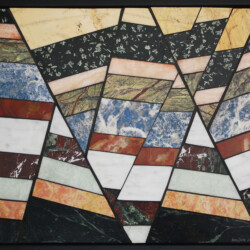 A stained glass window with a pattern of triangles.