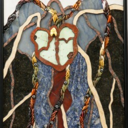 A stained glass picture of a tree with a heart on it.