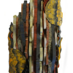 Waves VII: Terroir<br>
7” x 12.75”, 2019 <br>
Slate, nickeloan magnesite, travertine, serpentinite marble, alabaster, gabbro, jasper <br>
Slabs: Arsenic sulfur calcite <br>
Stone discs: Jasper, onyx, hematite, unakite A sculpture of various colors and shapes with yellow, red, brown, black and white.