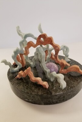 Convolution Evolution <br> 9" x 8 1/2" x 9 1/2", 2019 <br> Marble, travertine, lepidolite sphere A sculpture of coral and rocks on top of a marble base.
