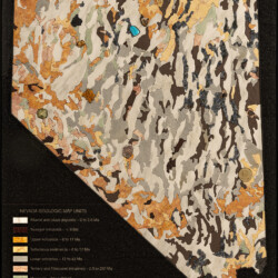 Nevada Geologic Map <br> 34 3/4" x 24 1/4", 2020 <br> Slabs: Marble, serpentine breccia, travertine, sodalite syenite, slate, syenite <br> Specimen: Realgar, fire opal, clinoclase, gold nugget, vesuvianite, vanadinite on descloizite, creedite, barite, scholzite, turquoise, spessartine garnet, malachite pseudomorph after azurite; <br> Fossils: Olenellus fowleri A geologic map of Nevada created with different colored stones.