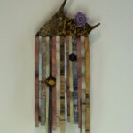 Waves XIV: Wing of Whimsy <br> 15" x 6 1/2" x 2 1/2", 2019 <br> Stomalitic jasper, quartz, serpentine, nickeloan magnesite, piemontite, slate, tiger's eye sphere, travertine, onyx, grunerite, sandstone, sodalite syenite, amethyst sphere, amethyst flower, marble A colorful wall hanging with some flowers and a bird perched on it.