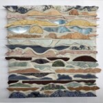 Waves XVII: Sea Foam <br> 14 1/2" x 14 1/2", 2020 <br> Slabs: lepidolite, pegmatite, travertine, marble, limestone, agatized quartz, quartzite, charoite, fuchsite with ruby, dumortiorite, piemontite, fuchsitic chert, sodalite syenite A painting of mountains and valleys with different colors.
