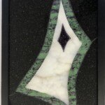 Drusy Diamond <br> 15.75” x 9.75” x 1.75”, 2022 <br> Gabbro, anyolite, quartz drusy, amethyst drusy A picture of the back side of a glass tile.