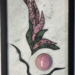 Flower Vignette I <br> 12” x 8.5” x 1.5”, 2022 <br> Marble, spider web rhodonite, anyolite, rhodonite sphere A picture of a pink stone and leaves.