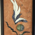 Flower Vignette II <br> 12.25” x 8.5”x 1.5”, 2022 <br> Sphere: chrysocolla
Slabs: marble, sodalite syenite, ruby with zoisite (anyolite) A picture of some kind of art work on the wall.