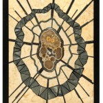 Reverberations <br> 15.75” x 12.75”x 2.0”, 2022 <br> Limestone; banded barite with marcasite; pyrite (faceted beads, cut concretions); marble strips A mosaic of a skull with a spider web.