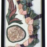 Apophyllite in Bloom <br> 8.25” x 18” x 9.75”, 2022 <br> Apophyllite crystal; slabs: marble, fuchsitic chert, rhodonite; tumbled: quartz, chert, charoite A picture of some plants and stones in a frame.