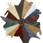 Triangles IV: Rainbow Ripple – 13” diameter, 2023 <br> Slate, travertine, marble, sodalite syenite, jasper, dumortieritic quartzite, limestone A circular collage of different colors and shapes.